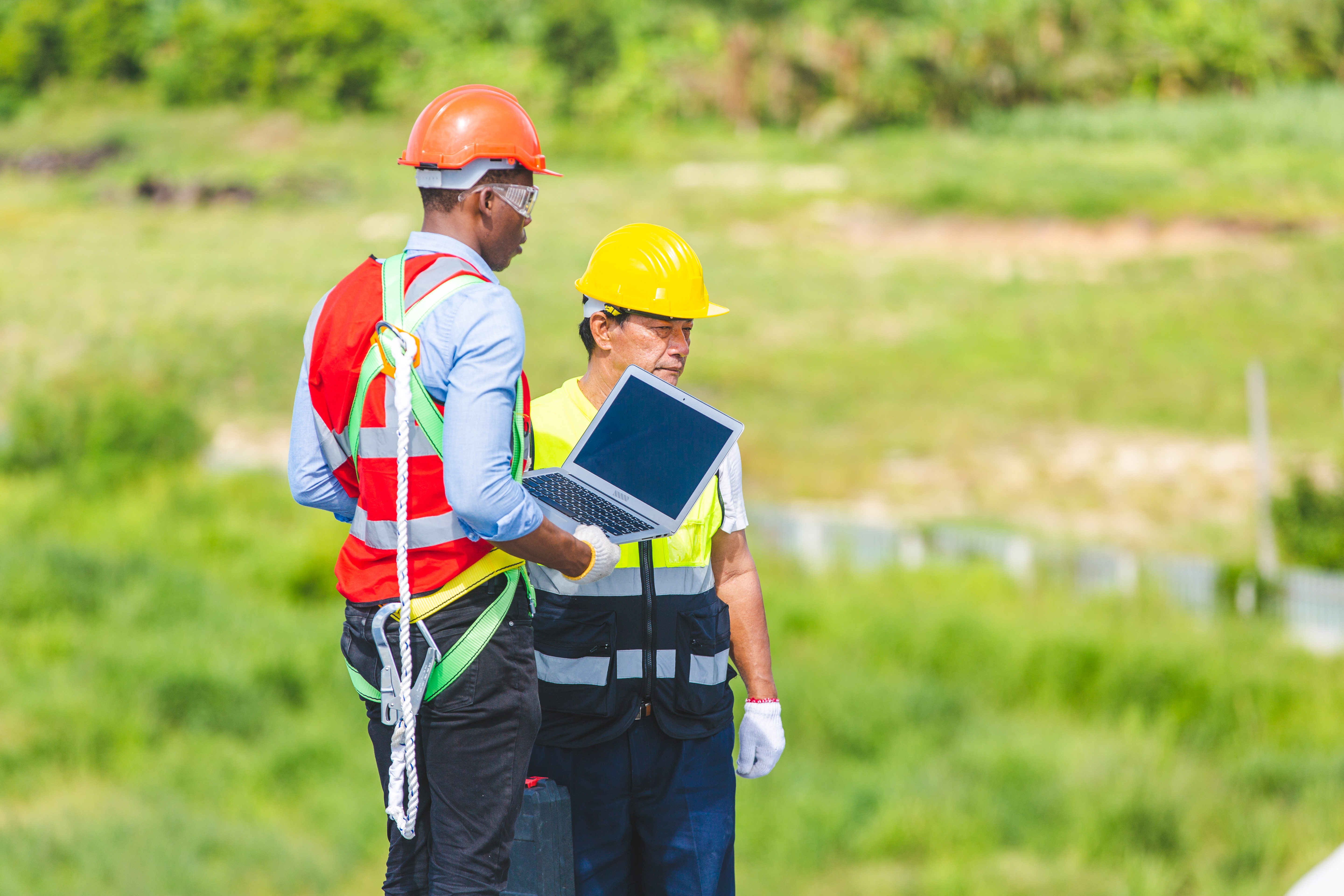 Technician engineer service meeting and checking solar cell on rooftop of industrial factory