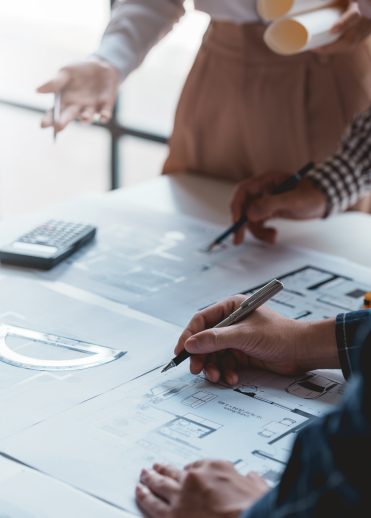 Architect or engineers are meeting to discuss home design. modify plans build a construction project