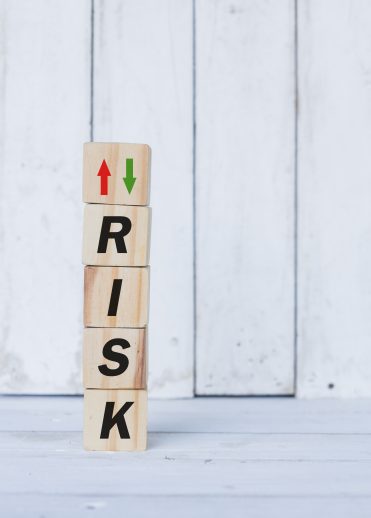 risk word or concept on wooden blocks, white wood background