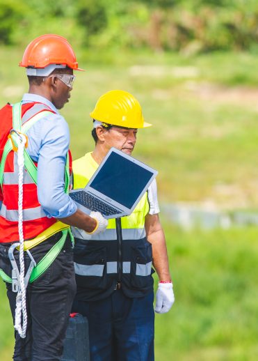 Technician engineer service meeting and checking solar cell on rooftop of industrial factory