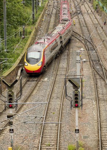 Train changing tracks at junction on railway tracks.